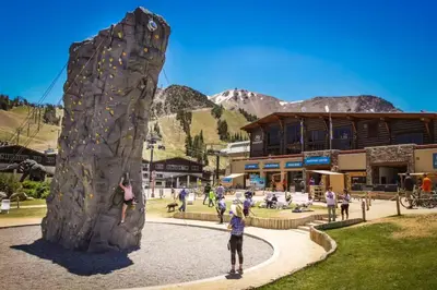 a group of people playing on a rock wall at La Residence N3 in Mammoth Lakes