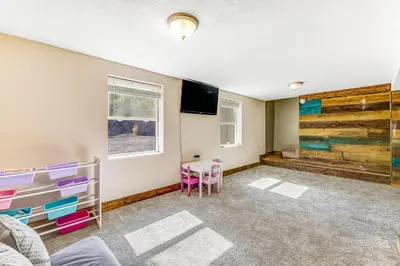 a room with a bed and a tv and a table at Wildcat Family Ranch in Murphys