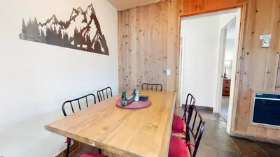 a dining room with a wooden table and chairs at San Sierra #26 condo in Mammoth Lakes