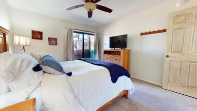 a bedroom with a bed and a flat screen tv at San Sierra #26 condo in Mammoth Lakes