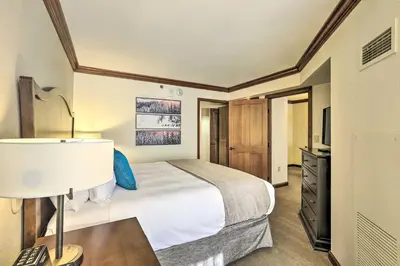 a hotel room with a bed and a desk with a lamp at 6 Mi to Lake Tahoe Everline Resort Retreat! in Olympic Valley