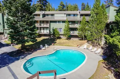 an aerial view of a hotel with a swimming pool at St Anton Wooded View 1-Bedroom Condos with Complimentary Hot Drinks in Mammoth Lakes