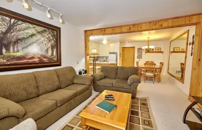 a living room with a couch and a table at St Anton Wooded View 1-Bedroom Condos with Complimentary Hot Drinks in Mammoth Lakes