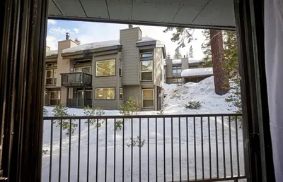 a view from a window of a building with snow at St Anton Wooded View 1-Bedroom Condos with Complimentary Hot Drinks in Mammoth Lakes