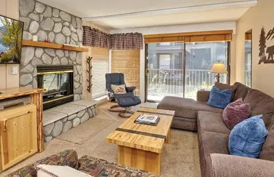 a living room with a couch and a fireplace at St Anton Street View Ski-In & Out 1-Bedroom Condo in Mammoth Lakes
