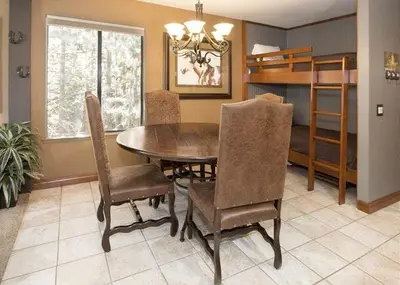 a dining room with a wooden table and chairs at St Anton Courtyard View Ski-In and Out 1 Bedroom Condo in Mammoth Lakes
