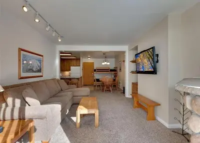 a living room with a couch and a table at St Anton Courtyard View Ski-In and Out 1 Bedroom Condo in Mammoth Lakes
