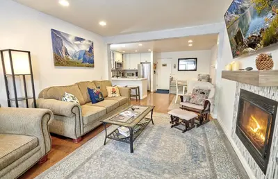 a living room with a couch and a fireplace at St Anton Condos with Rec Center in Mammoth Lakes