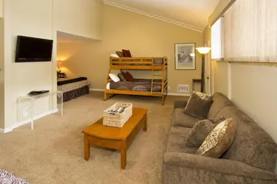 a living room with a couch and a bed at St Anton Street View 2-Bedroom Condo with full kitchen in Mammoth Lakes