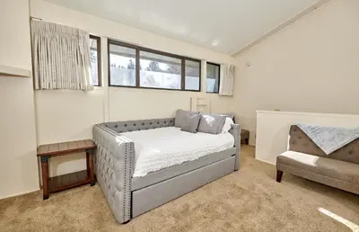 a living room with a couch and a chair at St Anton Courtyard View 2-Bedroom Condo with full kitchen in Mammoth Lakes