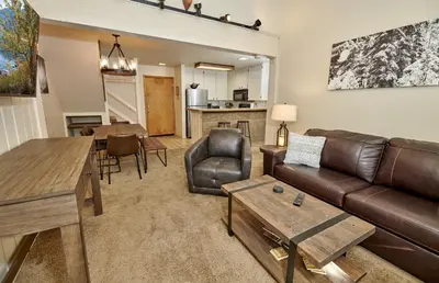 a living room with a couch and a table at St Anton Courtyard View 2-Bedroom Condo with full kitchen in Mammoth Lakes