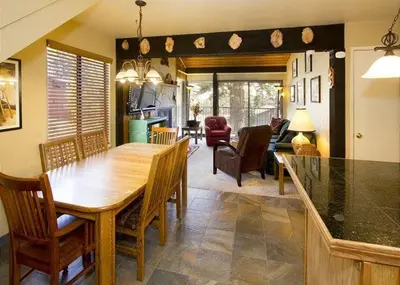 a dining room and living room with a table and chairs at St Anton Courtyard View 2-Bedroom Condo with full kitchen in Mammoth Lakes