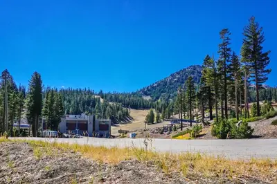 a building on the side of a road with trees at St Anton Courtyard View 1-Bedroom Condos with Dry Sauna in Mammoth Lakes