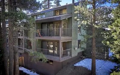 an exterior view of a house with trees at St Anton Courtyard View 1-Bedroom Condos with Dry Sauna in Mammoth Lakes