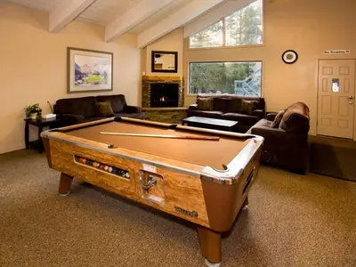 a living room with a pool table in it at St Anton Wooded View 2-Bedroom Condos with Ski Lockers in Mammoth Lakes