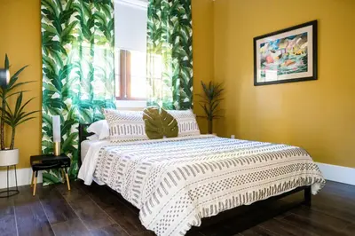 a bedroom with a bed with a white comforter at Sacramento Guest House with Patio about 5 Mi to Downtown in Sacramento