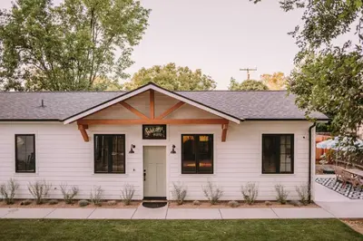 a white house with black windows at Sacramento Guest House with Patio about 5 Mi to Downtown in Sacramento
