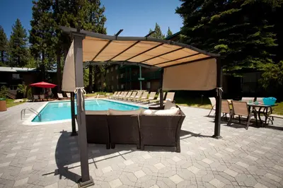 a pavilion over a pool with chairs and a table at Forest Suites Resort at the Heavenly Village in South Lake Tahoe