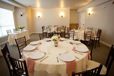 a banquet room with tables and chairs with white plates at Forest Suites Resort at the Heavenly Village in South Lake Tahoe