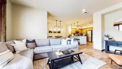 a living room with a couch and a table at Woodwinds #1265 townhouse in Mammoth Lakes