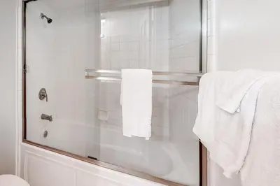 a bathroom with a shower with white towels at Inntopia in Zephyr Cove