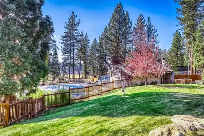 a yard with a fence and a pool at Inntopia in Zephyr Cove
