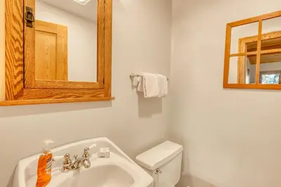a bathroom with a sink and a toilet and a mirror at Our Lake House in Zephyr Cove