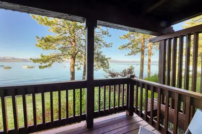 a view from the porch of a cabin overlooking the water at Our Lake House in Zephyr Cove