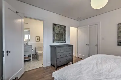 a bedroom with a bed and a bathroom with a sink at Reno Home Less Than 1 Mile to Midtown and Truckee River in Reno