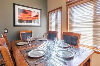 a dining room table with plates and glasses on it at Snowcreek V 963 in Mammoth Lakes