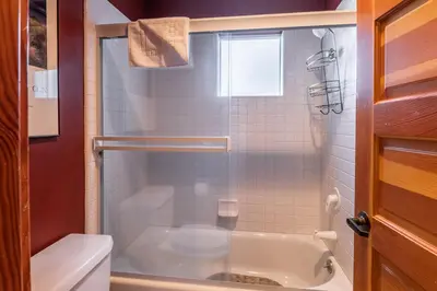 a bathroom with a shower with a tub and a toilet at Snowcreek V 963 in Mammoth Lakes