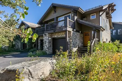a house with a balcony and a driveway at Snowcreek V 963 in Mammoth Lakes
