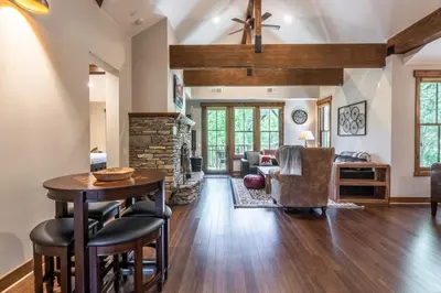 a living room with a table and a fireplace at Lodges 1138 in Mammoth Lakes