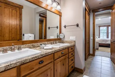 a bathroom with two sinks and a large mirror at Lodges 1138 in Mammoth Lakes