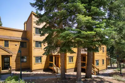 a large wooden house with trees in front of it at Northstar - Gold Bend Getaway in Truckee