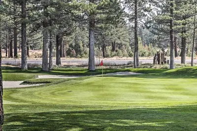 a view of a golf course with a green at Modern Mammoth Lakes Condo Ski, Hike, and More! in Mammoth Lakes