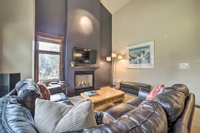 a living room with a leather couch and a fireplace at Modern Mammoth Lakes Condo Ski, Hike, and More! in Mammoth Lakes
