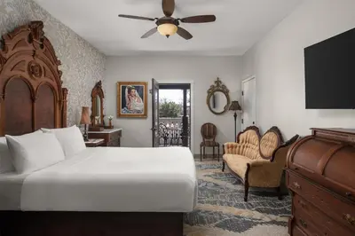 a bedroom with a bed with a ceiling fan at National Hotel Jackson, Tapestry Collection by Hilton in Jackson