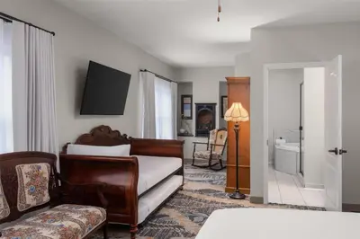a living room with a bed and a couch at National Hotel Jackson, Tapestry Collection by Hilton in Jackson