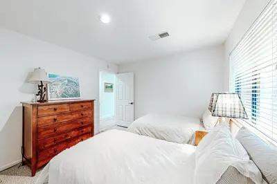 a bedroom with two beds and a dresser and a window at Grey Fireplace in Truckee