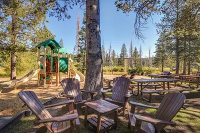a park with tables and chairs and a playground at Grey Fireplace in Truckee