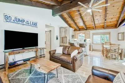 a living room with a tv and a couch at The Lazy Golden Cabin in South Lake Tahoe