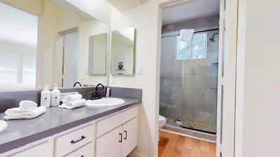 a white bathroom with a sink and a shower at Snowcreek #840 condo in Mammoth Lakes