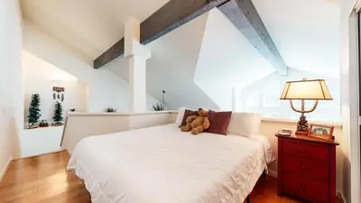 a teddy bear sitting on a bed in a bedroom at Snowcreek #840 condo in Mammoth Lakes