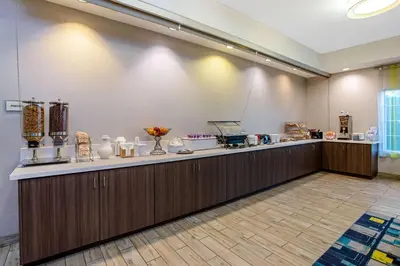 a lobby with a counter with vases on it at La Quinta by Wyndham Manteca - Ripon in Ripon