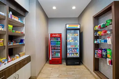 a coca cola refrigerator in a store aisle at La Quinta by Wyndham Manteca - Ripon in Ripon