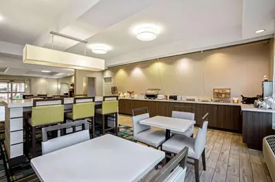 a restaurant with tables and chairs and a counter at La Quinta by Wyndham Manteca - Ripon in Ripon