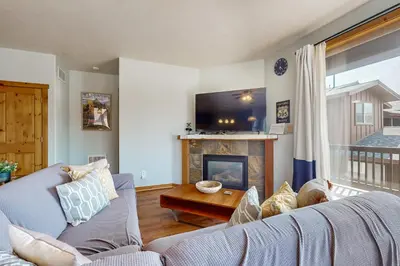 a living room with a couch and a fireplace at Truckee Living in Truckee