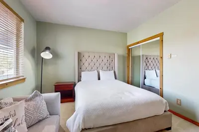 a bedroom with a large white bed and a couch at Truckee Living in Truckee