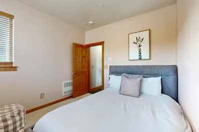 a bedroom with a large bed with a blue headboard at Truckee Living in Truckee